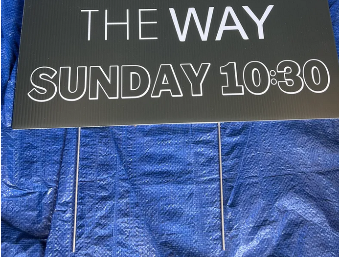 a yard sign with metal wire stakes